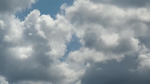 Fluffy White Clouds Time Lapse Against Blue Sky