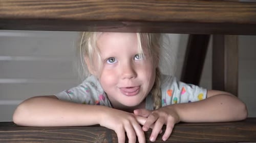 Child Leans on Staircase Railing