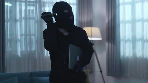 Masked Person Entering Home at Night