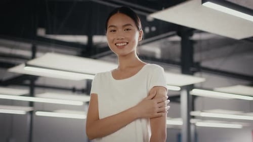 Vaccinated Woman Posing Touching Arm After Vaccination In Modern Office