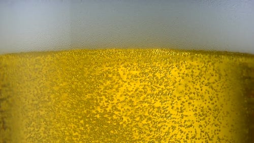 Extreme close-up beer bubbles in glass, Slow Motion