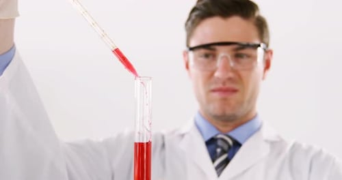 Scientist Pours Red Liquid into Test Tube
