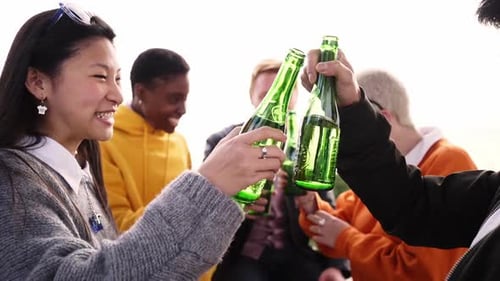 Friends Toasting Drinks Together Outdoors in Urban Setting