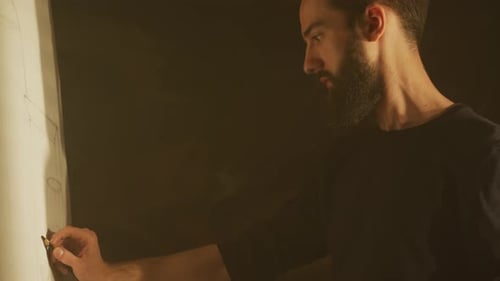 Bearded Man Drawing on Large Paper