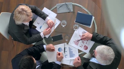 Business Team Meeting Analyzing Financial Data