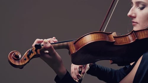 Girl Violin Playing at Studio. Woman Is Practicing Playing Musical Instrument
