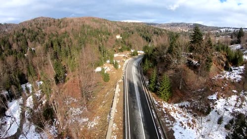 Aerial View Of Road Through Pine Forest In Winter