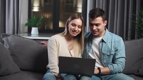Couple Using Laptop for Video Call at Home