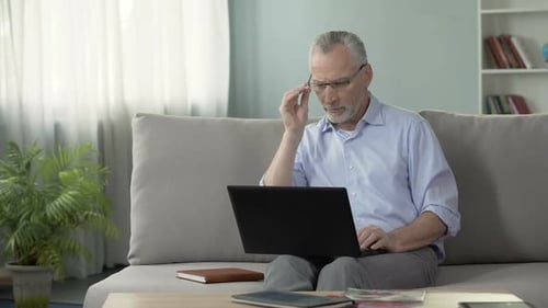 Senior Man Working on Laptop at Home