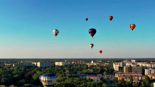 Beautiful balloons fly over the forest, park, city. Beautiful evening balloon flight.