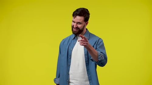 Expressive Man Gesturing on a Yellow Background