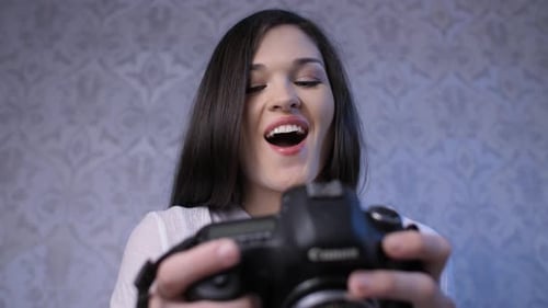 Woman Reviewing Photos on Camera Display