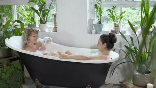 Women Relaxing in Bubble Bath at Home