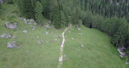 Aerial drone view of hikers hiking in the mountains.
