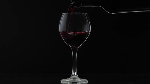 Red Wine Being Poured into Clear Glass