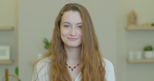 Smiling Young Woman with Auburn Hair