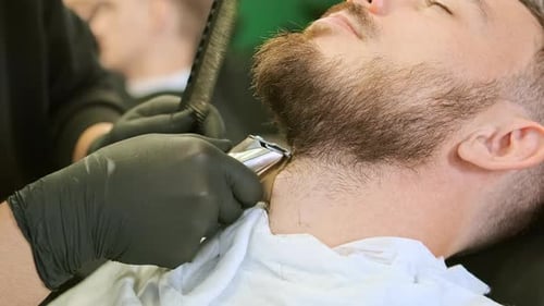 Barber Hands Hold Special Tool and Trim Customer Beard