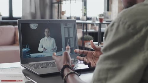 Man Attending Online Video Conference on Laptop