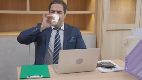 Young businessman sitting and looking to document in folder for audit at the office.