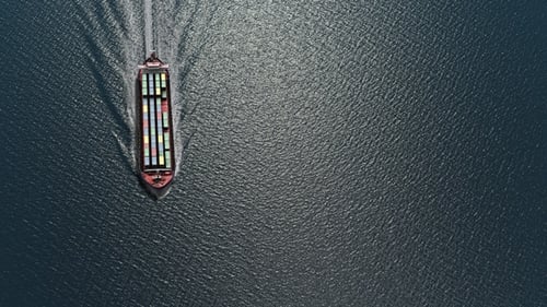 Large cargo ship carrying containers in the sea- Aerial