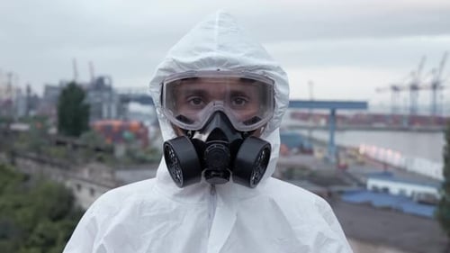 Person Takes off Hazmat Suit and Gas Mask