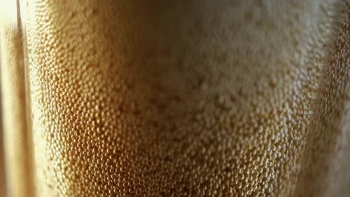 Close-up of Bubbly Brown Liquid Being Poured