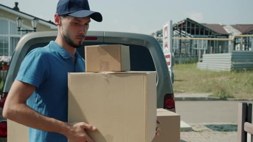 Portrait of Guy in Uniform Delivering Cargo Unloading Van and Carrying Parcels to House