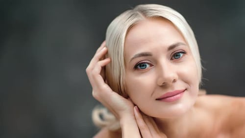 Closeup Portrait Pretty Blonde Female Posing Looking at Camera Isolated at Black Studio Background