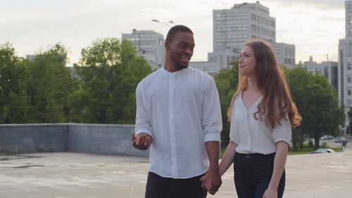 Couple Holding Hands Walking in a City