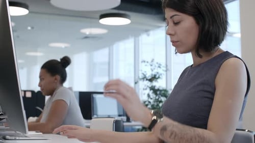 Female Office Workers Typing on Computers