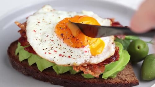 Avocado Toast with Fried Egg on White Plate