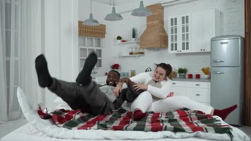 Playful Couple Having Fun on Bed Indoors