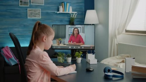 Young Girl Attends Online Tutoring Session at Home