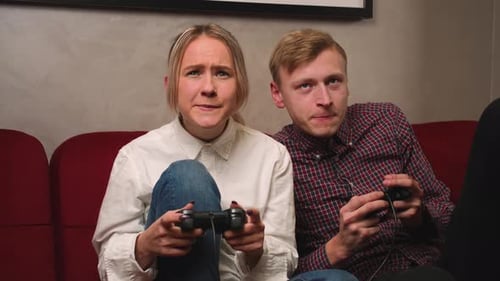 Young Couple Playing Video Game on Couch