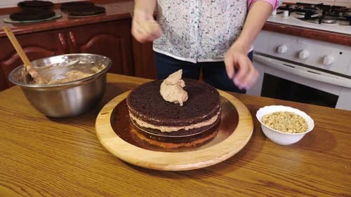 Woman Frosting a Delicious Chocolate Layer Cake