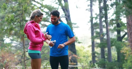 Couple checking a time in forest