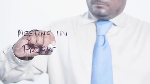 Asian Businessman Writes Meeting In Progress