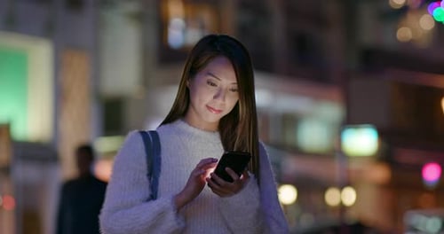 Woman Use of Mobile Phone at Street in The Winter Time