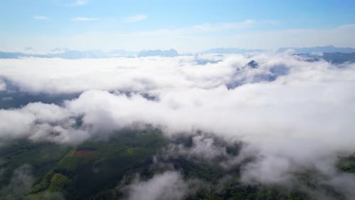 An aerial view from a drone flying over the many fogs in the mountains