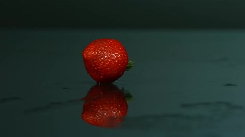 Strawberry Rotating on Wet Reflective Surface