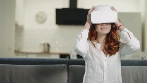 Woman Puts on VR Headset at Home
