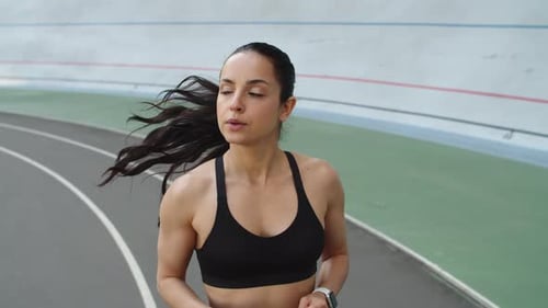 Runner Woman Jogging on Sport Track at Stadium. Sport Woman Running