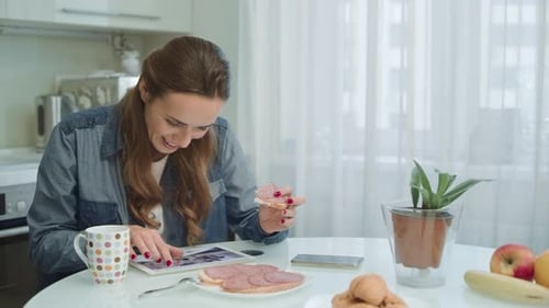 Woman Using Tablet at Breakfast. Housewife Having Nutrition Brunch at Home.