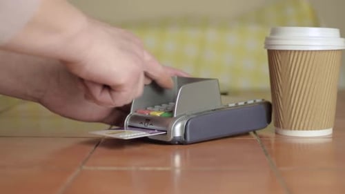 Credit Card Payment with Coffee Cup Near