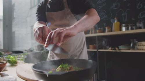 Chef Preparing a Meal in Steaming Frying Pan