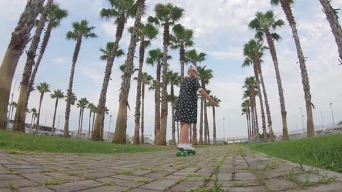 Girl Riding on Skateboard in Tropical Park. Active Outdoor Sport for Kids.