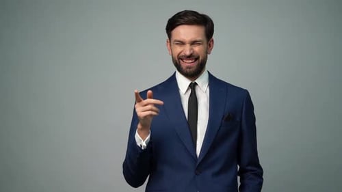 Happy Man in Suit Points and Laughs