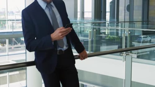 Businessman using smartphone in modern office building