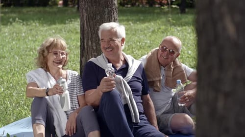 Senior Friends Relaxing and Laughing in the Park