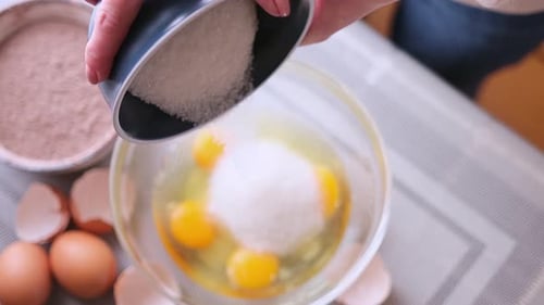 Dough Preparation Woman Cook Pours Sugar to Glass Bowl with Crushed Eggs